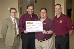 Pictured l to r: Teambackers Treasurer Adam Maruska, ’00, and President Tom Helgeson donated $20,000 to student-athlete scholarships on behalf of the Teambackers Board. Bill Tyrrell, director of Athletic Fundraising and Corby Kemmer, director of Development & Alumni Relations, accepted the check.